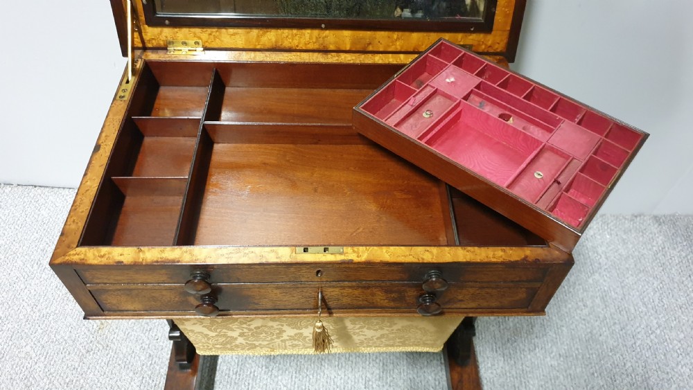 A William IV mahogany sewing table featuring two drawers with turned knobs, a gold fabric well underneath, and trestle supports joined by a turned stretcher. View VI
