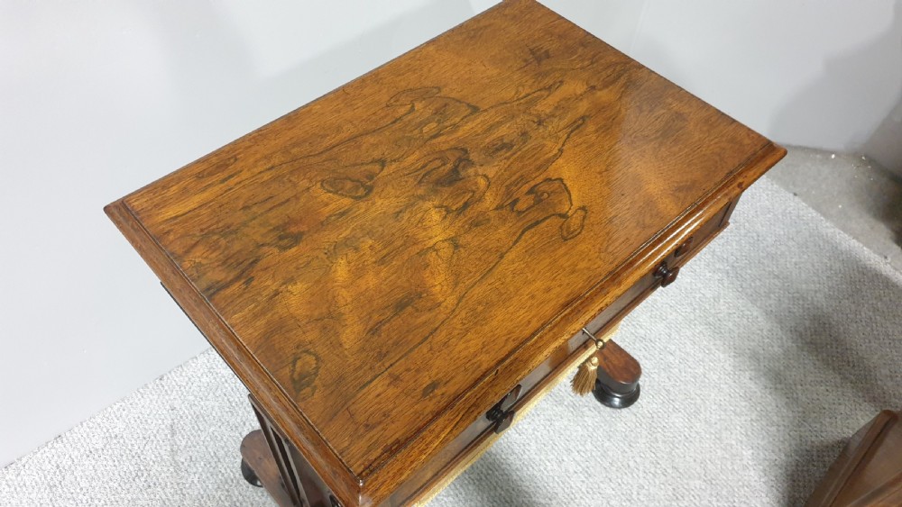 A William IV mahogany sewing table featuring two drawers with turned knobs, a gold fabric well underneath, and trestle supports joined by a turned stretcher. View VII