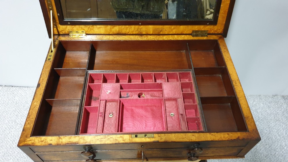 A William IV mahogany sewing table featuring two drawers with turned knobs, a gold fabric well underneath, and trestle supports joined by a turned stretcher. View X