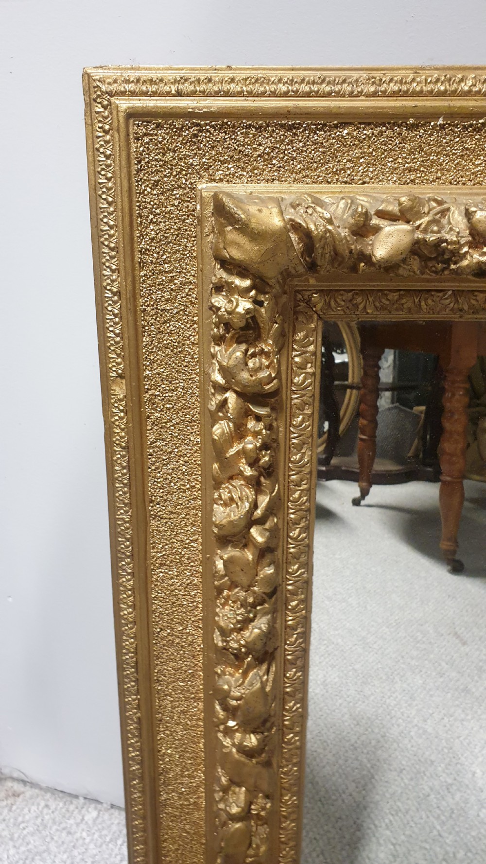 A matching pair of rectangular Victorian wall mirrors featuring ornate floral gesso moulding and a burnished gold finish. View IV