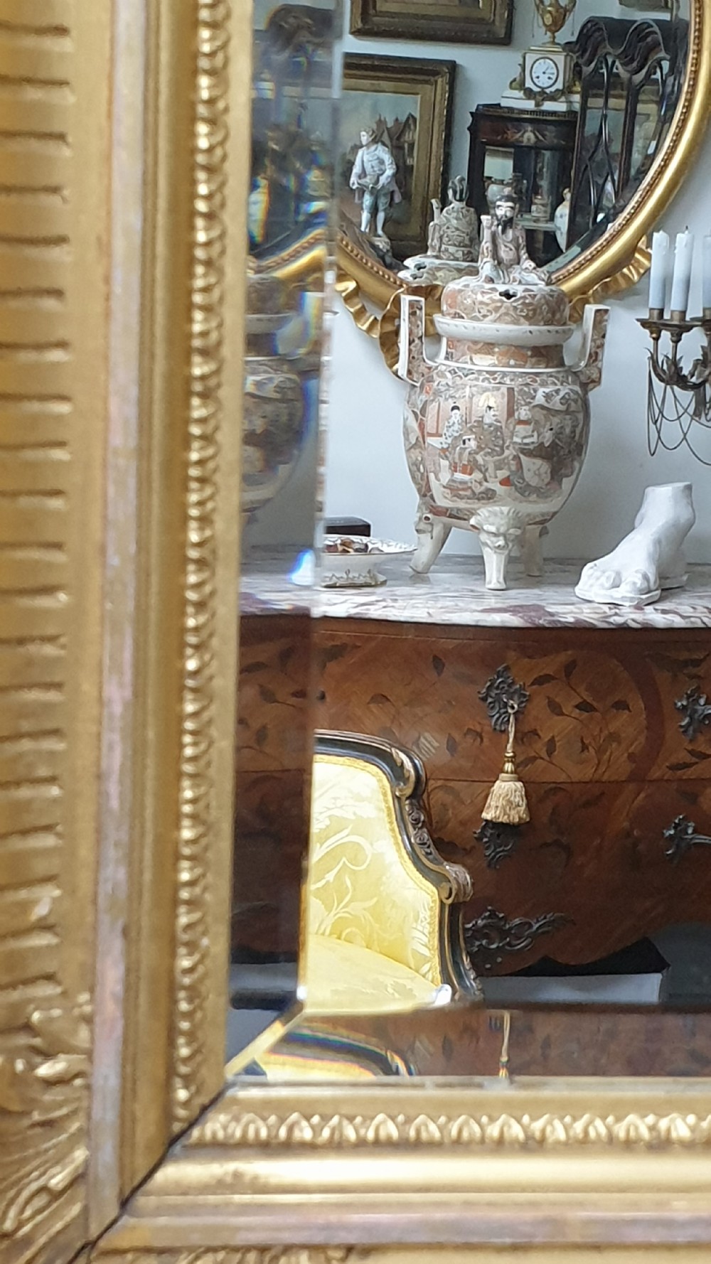 A rectangular antique wall mirror featuring a detailed gold giltwood frame with fluted moulding, leaf trim, and bevelled glass. View VIII