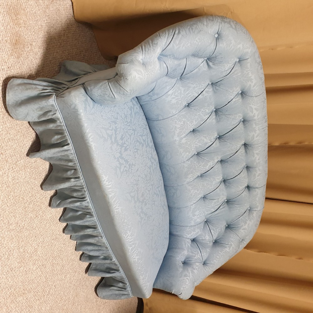 A light blue damask upholstered two-seater settee featuring deep buttoning across the backrest and a pleated base skirt. View VIII