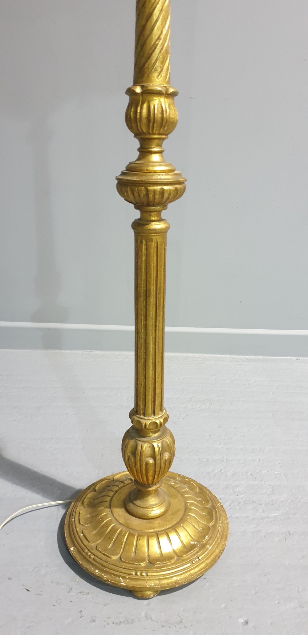 A tall gilded standard lamp featuring a carved fluted column and a cream fabric lampshade trimmed with fringe and tassels. View III