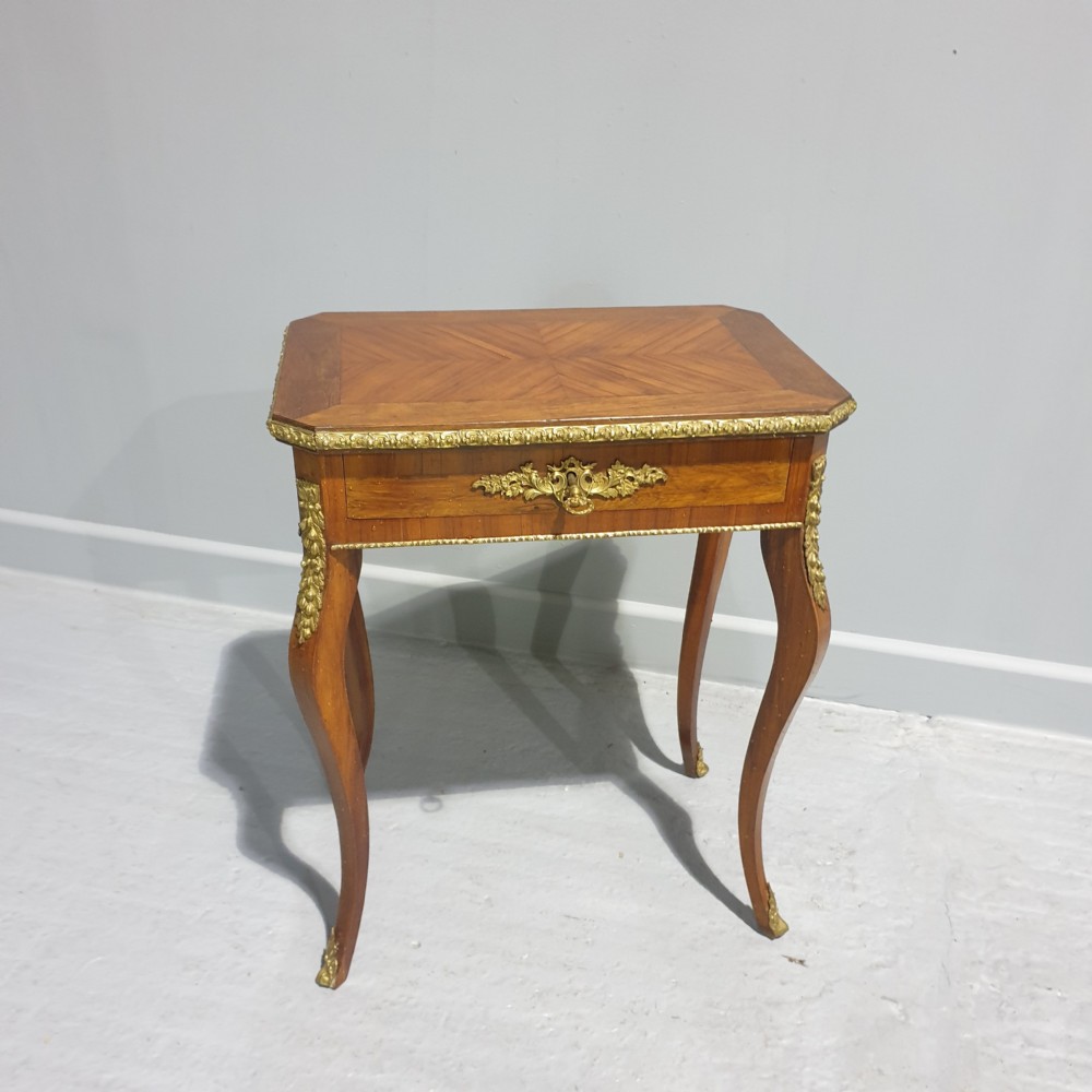 A rectangular French kingwood side table featuring parquetry top veneer, cabriole legs, and ornate cast ormolu mounts along the frieze and corners.