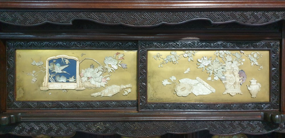 An intricately carved dark wood Japanese Meiji period Shibayama cabinet featuring multi-tiered asymmetrical shelves and gold lacquer panels inset with shell and bone motifs. View XX
