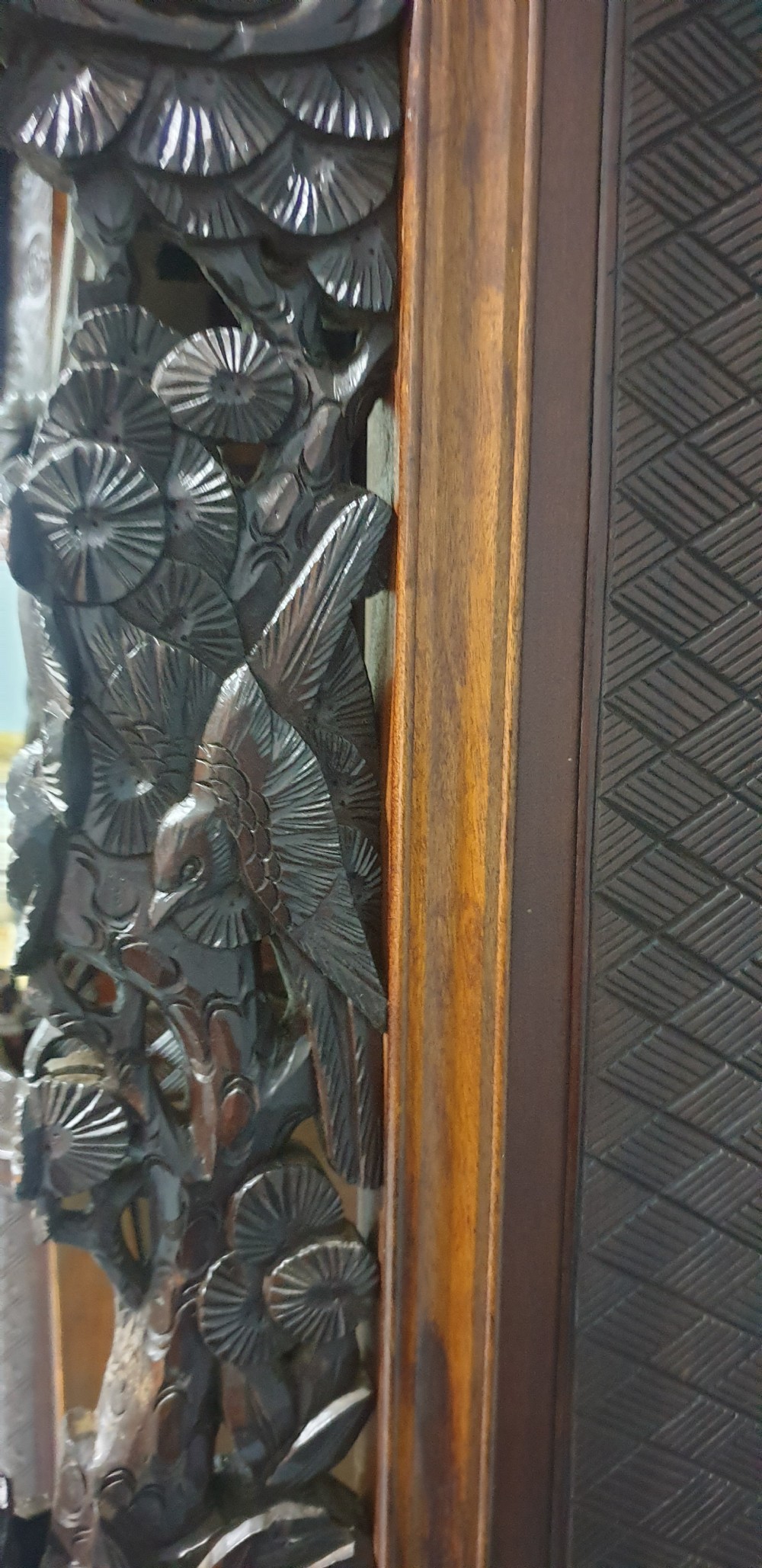 An intricately carved dark wood Japanese Meiji period Shibayama cabinet featuring multi-tiered asymmetrical shelves and gold lacquer panels inset with shell and bone motifs. View XXVI