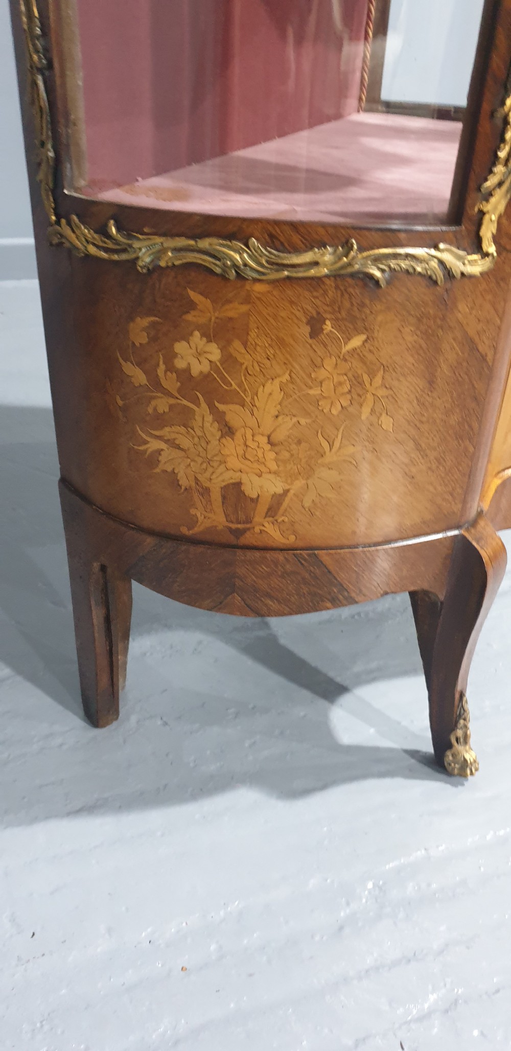 An antique French Louis XV style glazed vitrine display cabinet featuring curved glass sides, floral marquetry inlay, and detailed ormolu mounts. View V