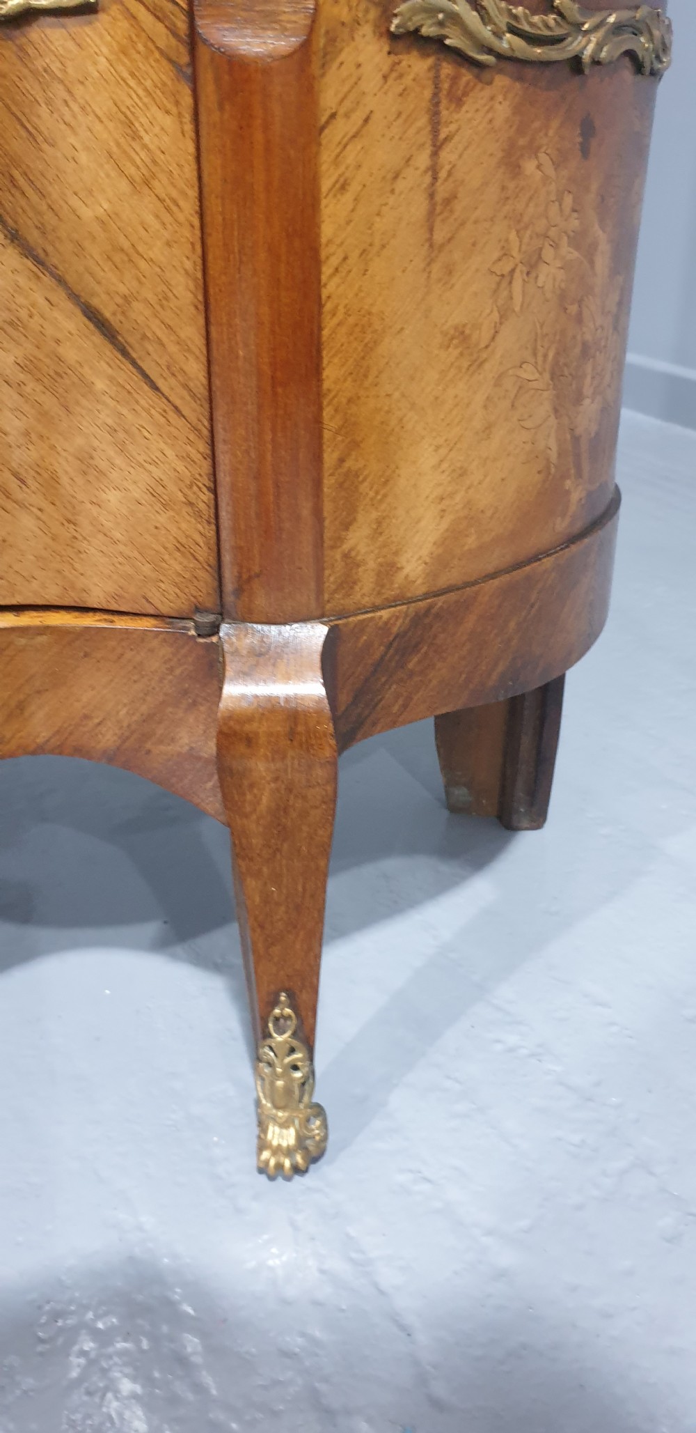 An antique French Louis XV style glazed vitrine display cabinet featuring curved glass sides, floral marquetry inlay, and detailed ormolu mounts. View VI