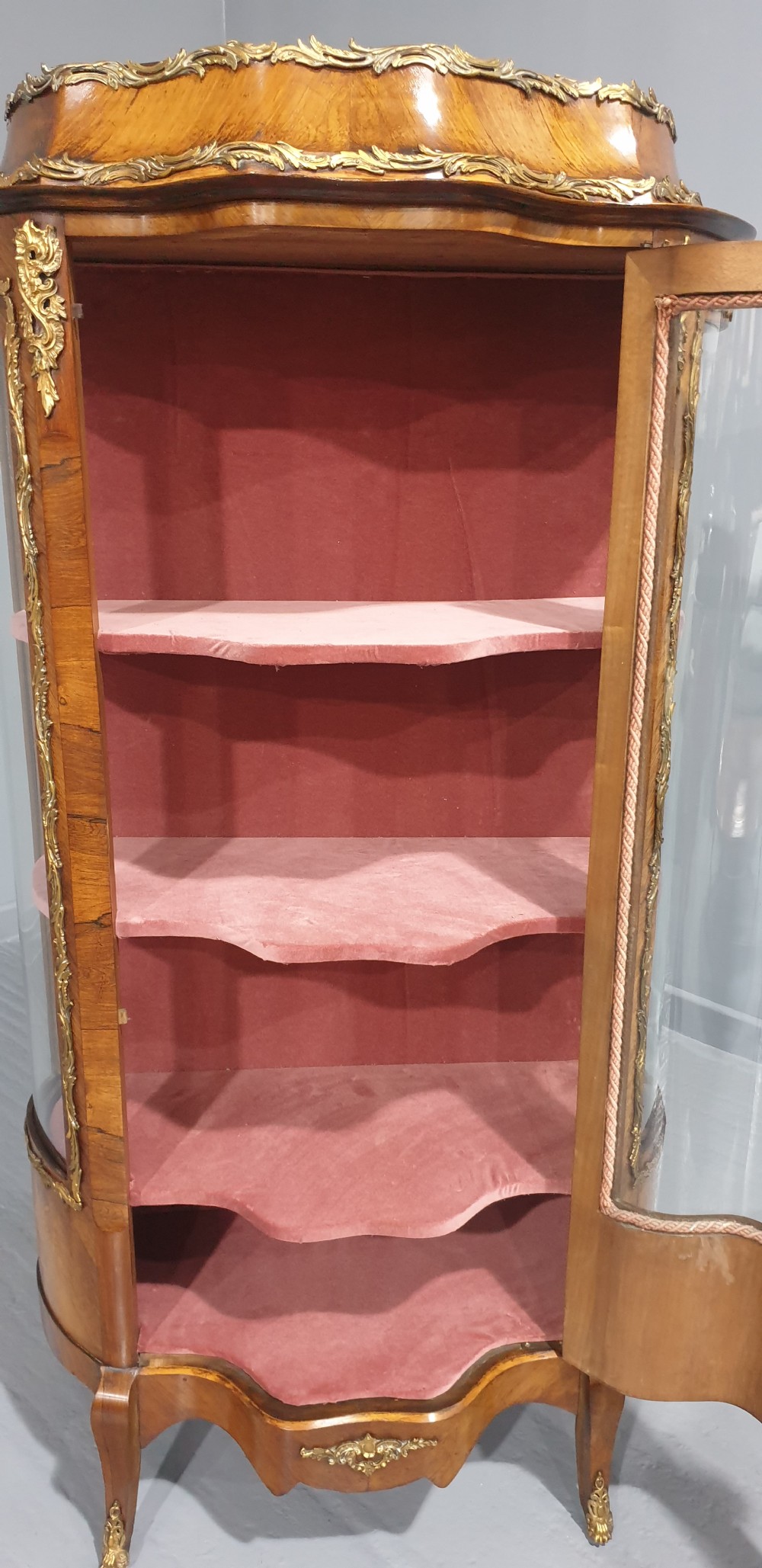 An antique French Louis XV style glazed vitrine display cabinet featuring curved glass sides, floral marquetry inlay, and detailed ormolu mounts. View XI