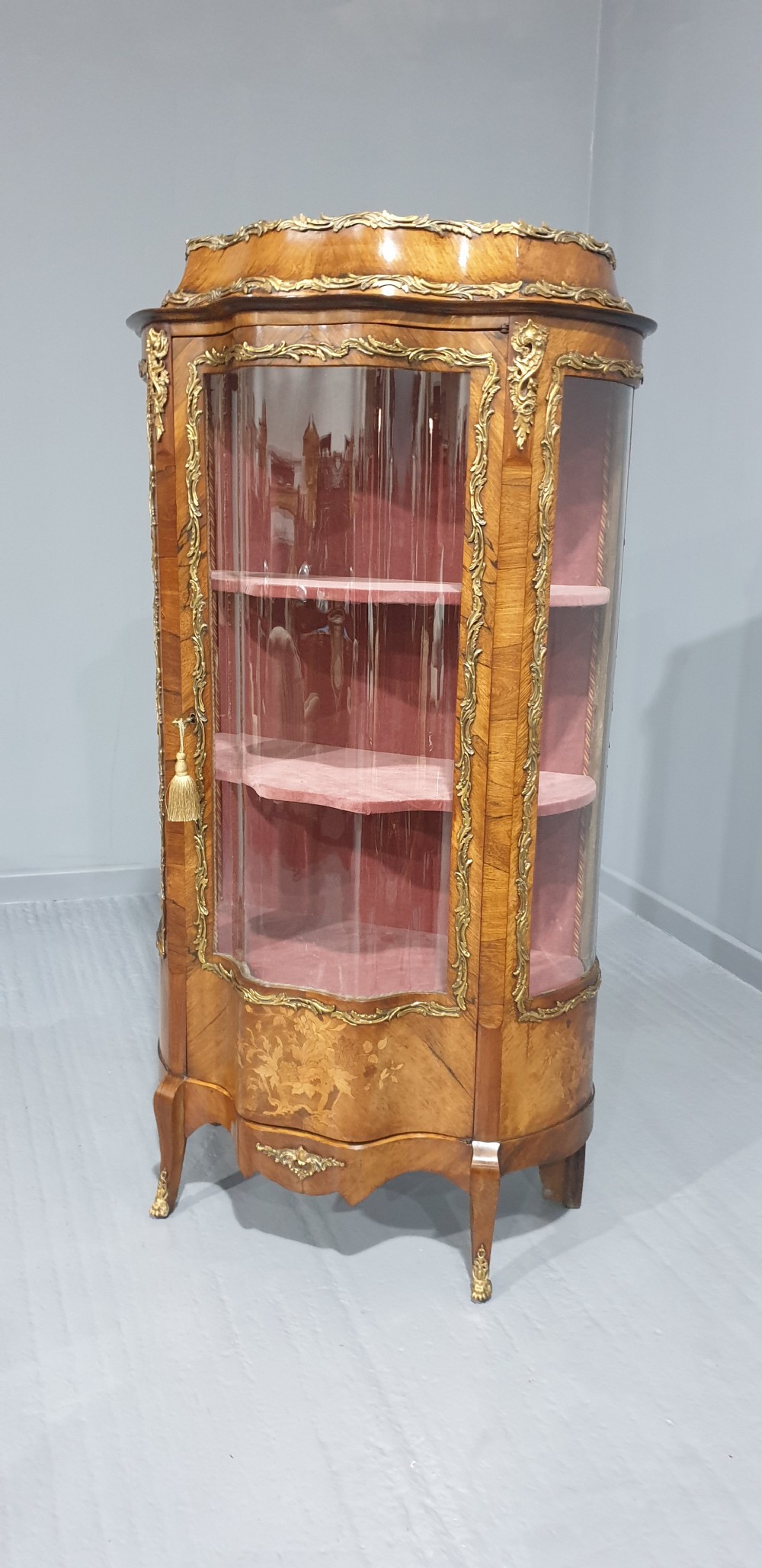 An antique French Louis XV style glazed vitrine display cabinet featuring curved glass sides, floral marquetry inlay, and detailed ormolu mounts. View XIII