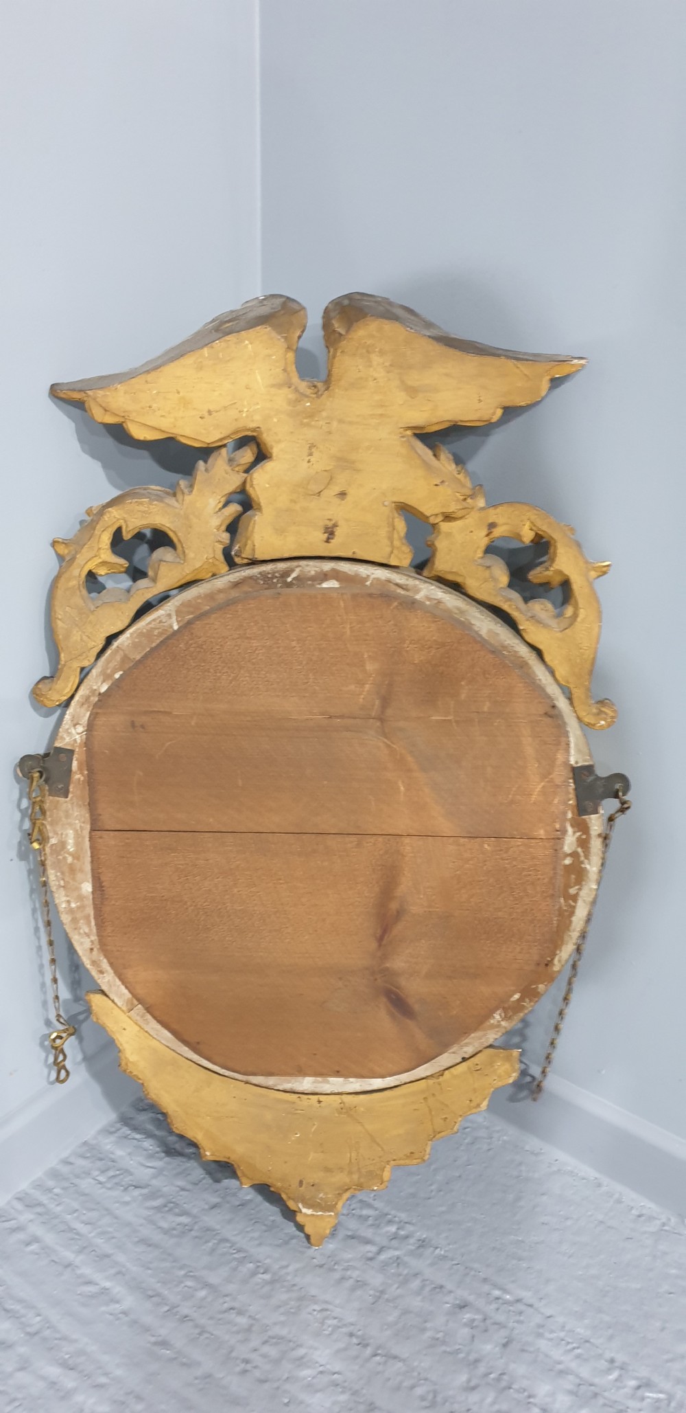An antique Regency giltwood convex wall mirror featuring a carved eagle cresting, ball-studded circular frame, and acanthus apron. View VIII