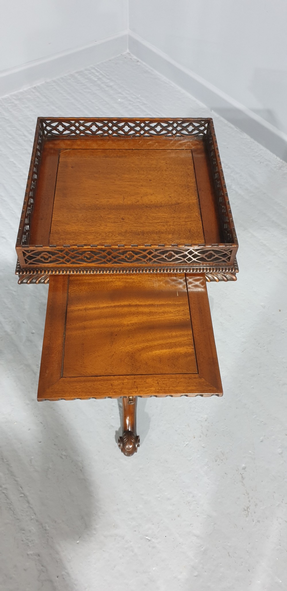A mahogany tripod occasional table featuring a fretwork gallery top, a pull-out candle slide, a carved central column, and three carved legs. View II