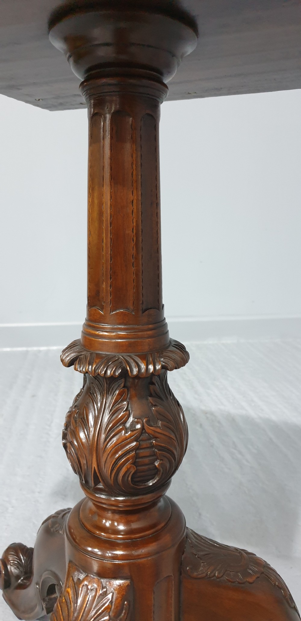 A mahogany tripod occasional table featuring a fretwork gallery top, a pull-out candle slide, a carved central column, and three carved legs. View V