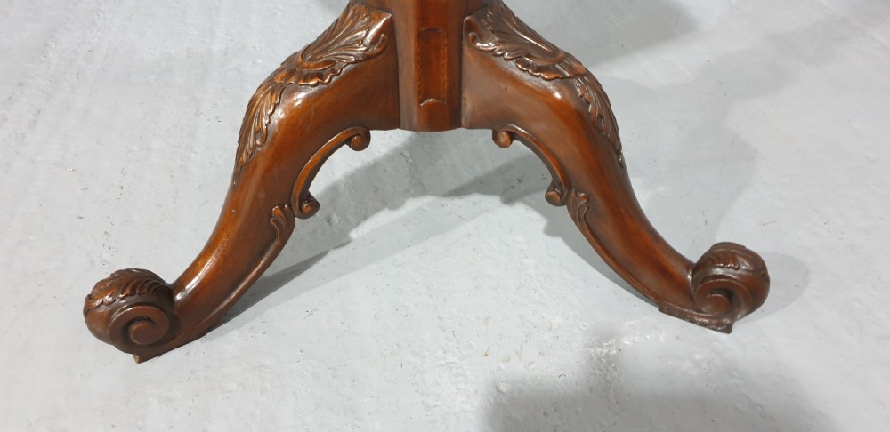 A mahogany tripod occasional table featuring a fretwork gallery top, a pull-out candle slide, a carved central column, and three carved legs. View VIII