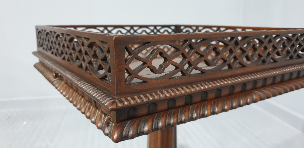 A mahogany tripod occasional table featuring a fretwork gallery top, a pull-out candle slide, a carved central column, and three carved legs. View XI