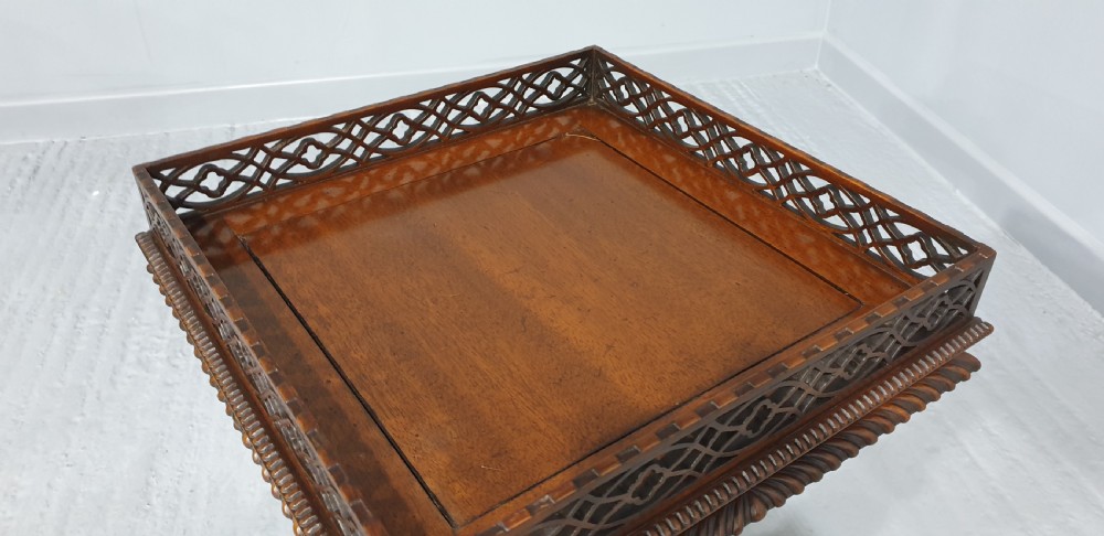 A mahogany tripod occasional table featuring a fretwork gallery top, a pull-out candle slide, a carved central column, and three carved legs. View XII