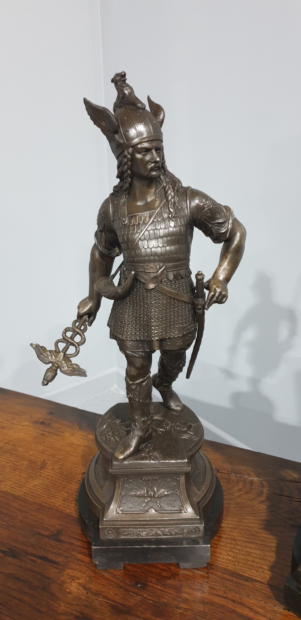 A pair of dark bronze-finished spelter statues depicting classical warriors wearing detailed armour and standing on relief-decorated bases. View III