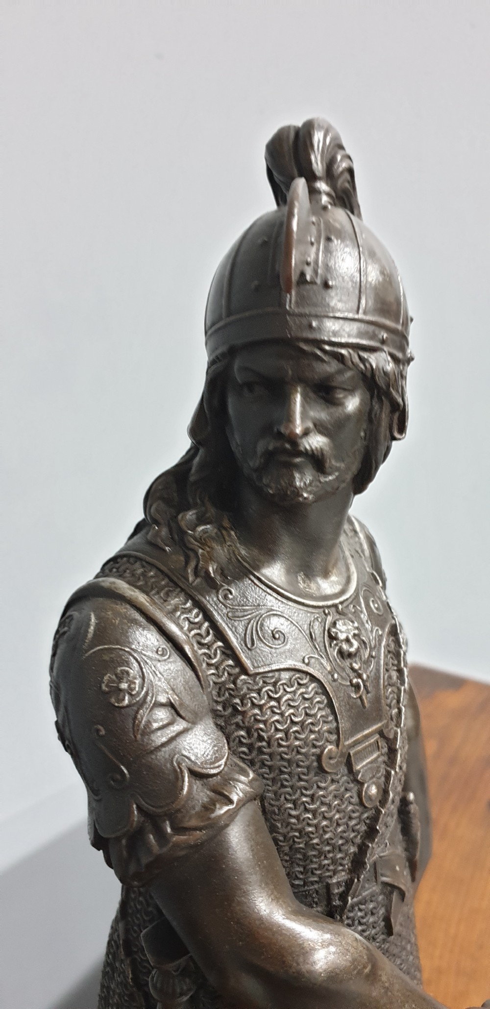 A pair of dark bronze-finished spelter statues depicting classical warriors wearing detailed armour and standing on relief-decorated bases. View V