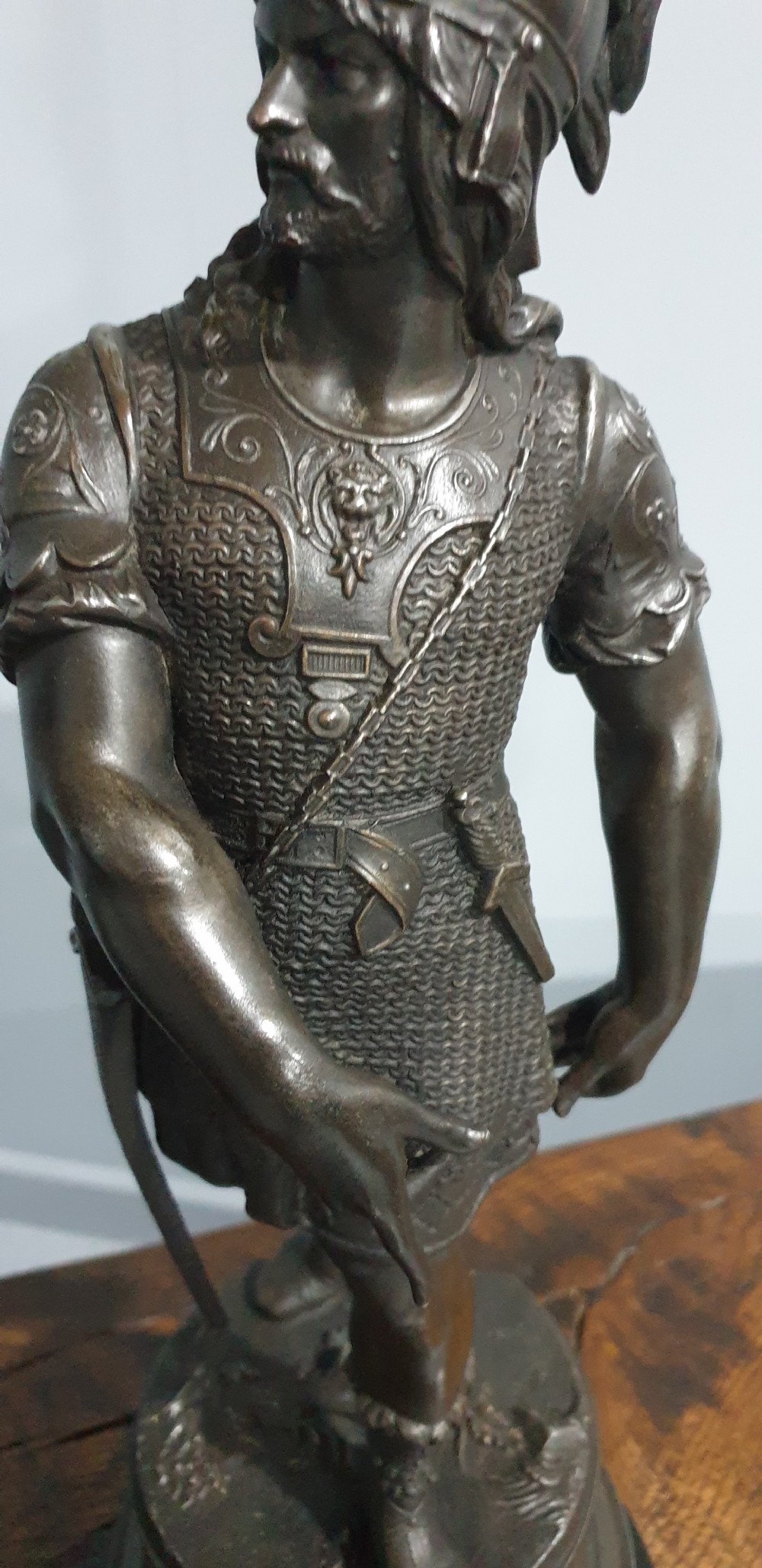 A pair of dark bronze-finished spelter statues depicting classical warriors wearing detailed armour and standing on relief-decorated bases. View VI
