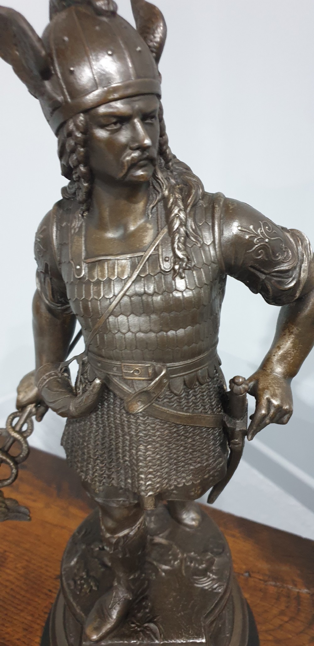 A pair of dark bronze-finished spelter statues depicting classical warriors wearing detailed armour and standing on relief-decorated bases. View VII