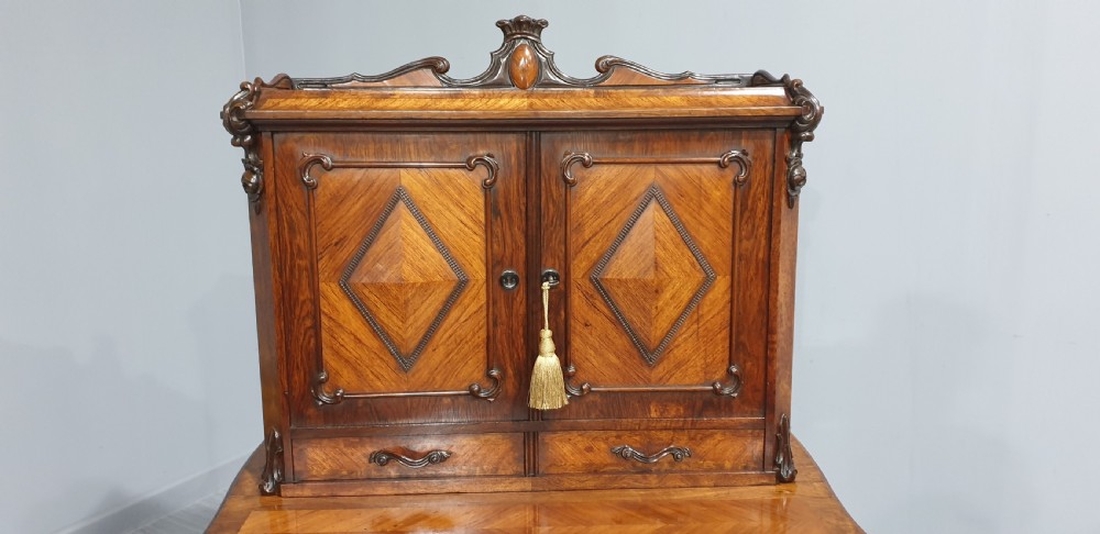 A French Bonheur du Jour writing desk in warm brown walnut with geometric diamond marquetry, cabriole legs, and an upper cabinet section with twin doors. View VIII