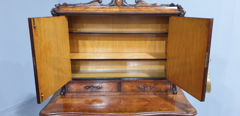 A French Bonheur du Jour writing desk in warm brown walnut with geometric diamond marquetry, cabriole legs, and an upper cabinet section with twin doors. View XIV