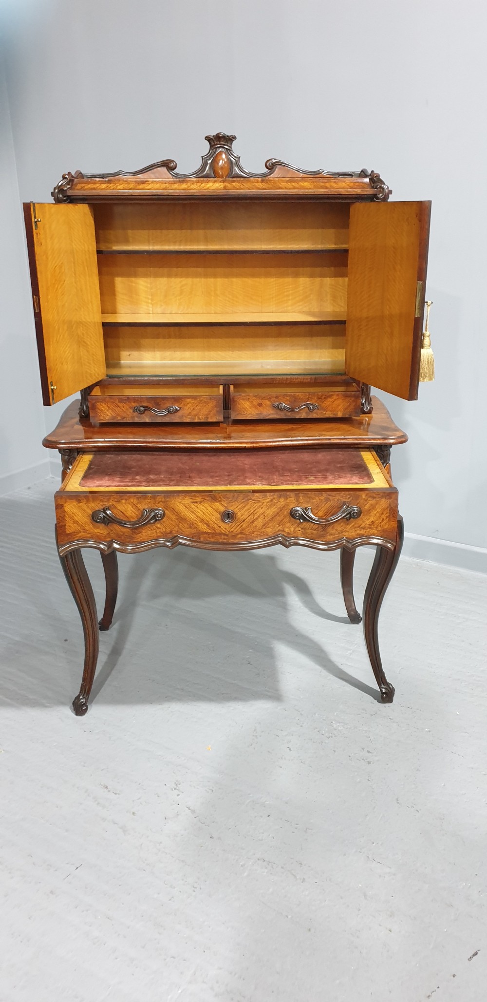 A French Bonheur du Jour writing desk in warm brown walnut with geometric diamond marquetry, cabriole legs, and an upper cabinet section with twin doors. View XV