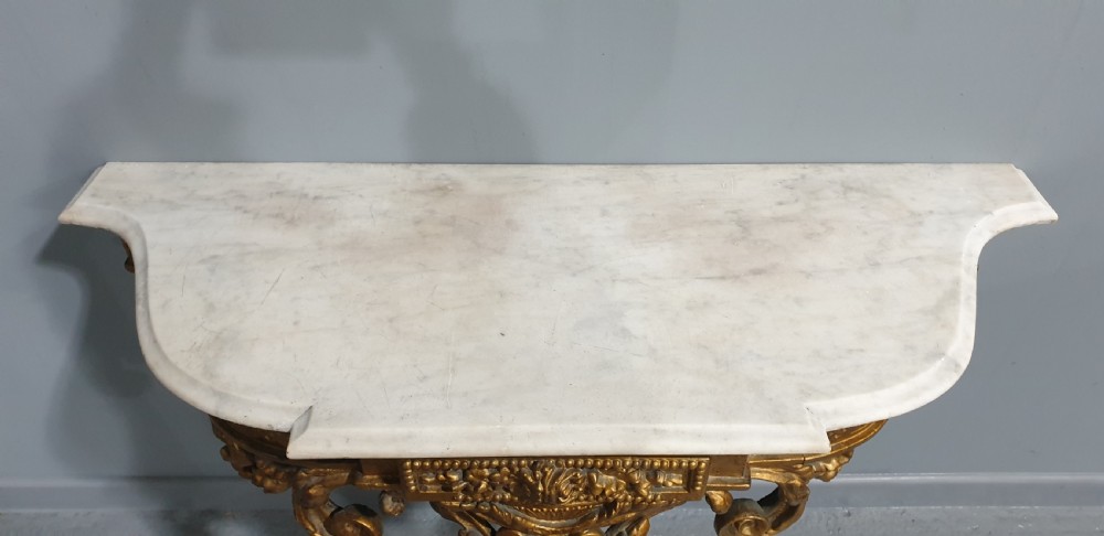 A 19th-century French giltwood wall-mounted console table featuring a single carved leg and a white marble top. View VIII