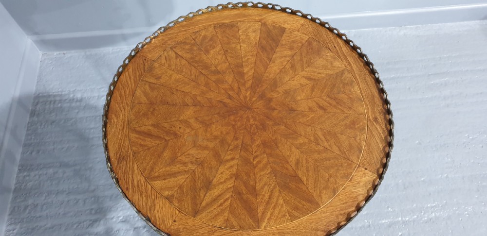 A round French side table featuring two tiers of sunburst parquetry veneer, decorative brass mounts, and a pierced gallery rim. View XI
