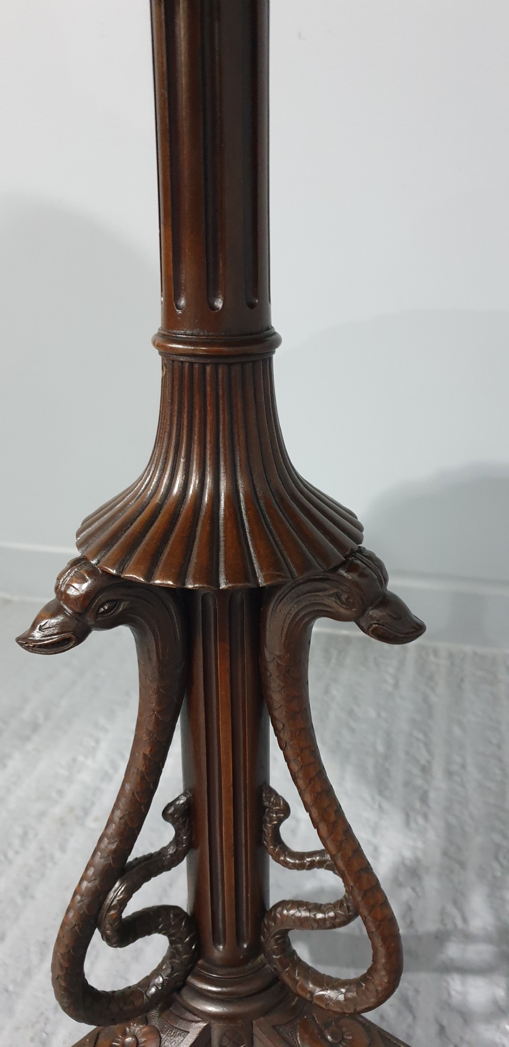 A mahogany tilt-top table with a pie-crust scalloped rim, resting on a carved tripod base with cabriole legs. View VI