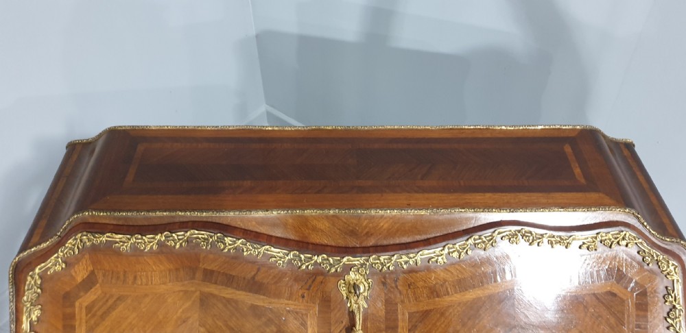 An early nineteenth-century French kingwood parquetry slant-front bureau featuring gilt-bronze ormolu mounts, cabriole legs, and geometric timber inlay. View III