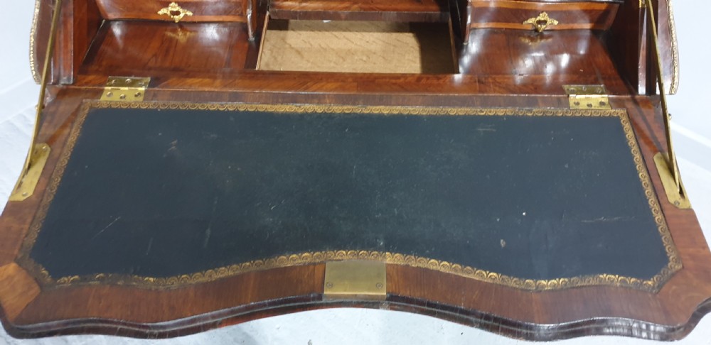 An early nineteenth-century French kingwood parquetry slant-front bureau featuring gilt-bronze ormolu mounts, cabriole legs, and geometric timber inlay. View VI