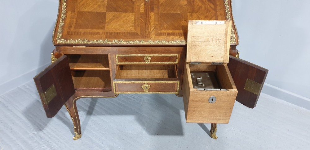 An early nineteenth-century French kingwood parquetry slant-front bureau featuring gilt-bronze ormolu mounts, cabriole legs, and geometric timber inlay. View VII