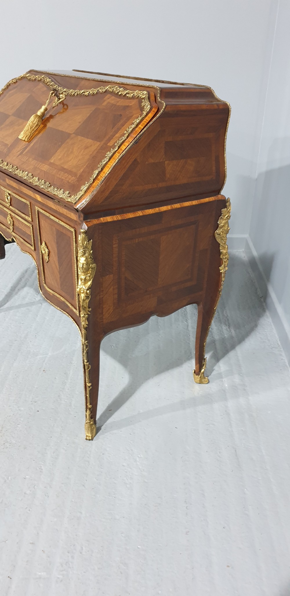 An early nineteenth-century French kingwood parquetry slant-front bureau featuring gilt-bronze ormolu mounts, cabriole legs, and geometric timber inlay. View VIII