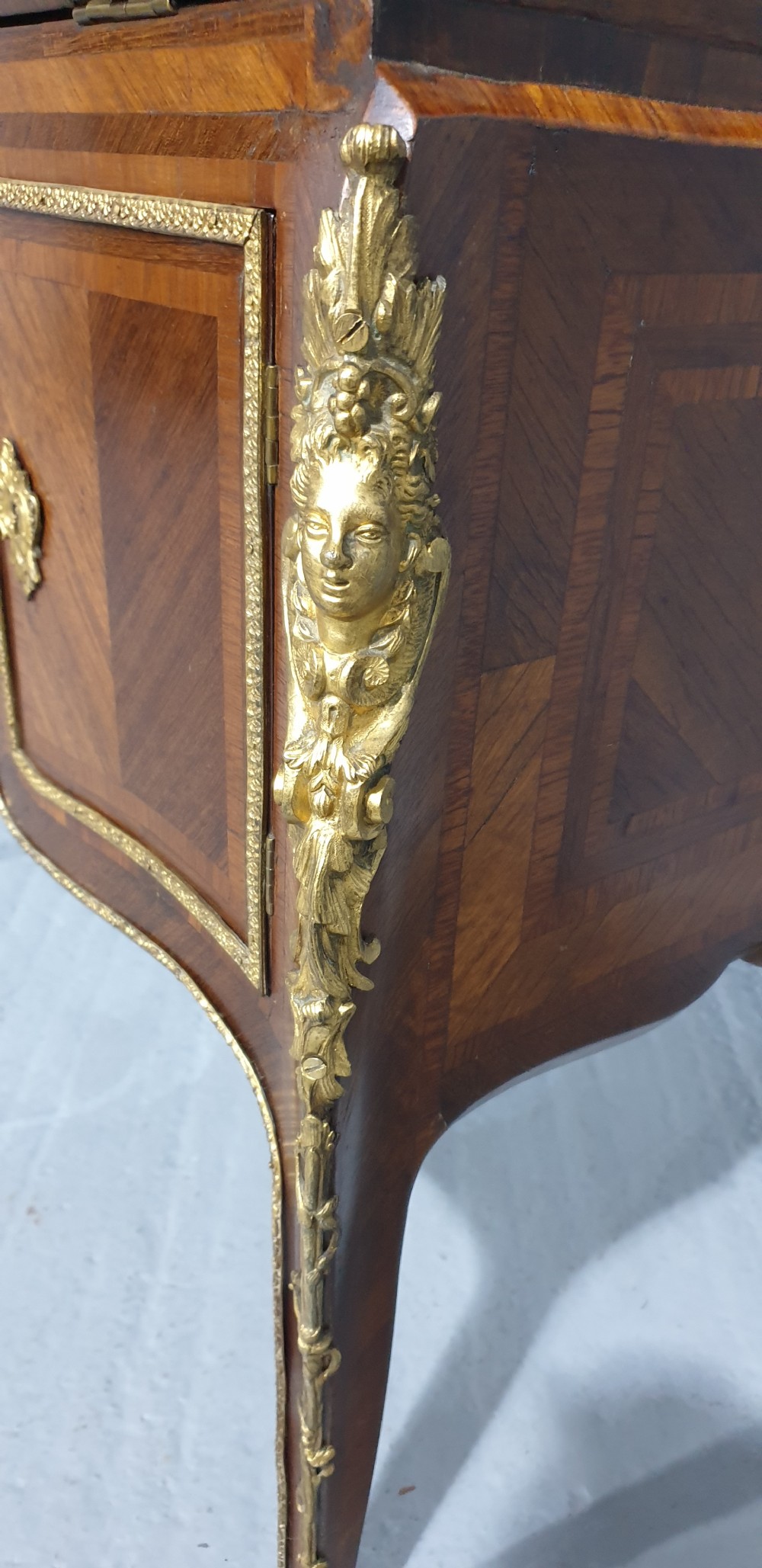 An early nineteenth-century French kingwood parquetry slant-front bureau featuring gilt-bronze ormolu mounts, cabriole legs, and geometric timber inlay. View IX