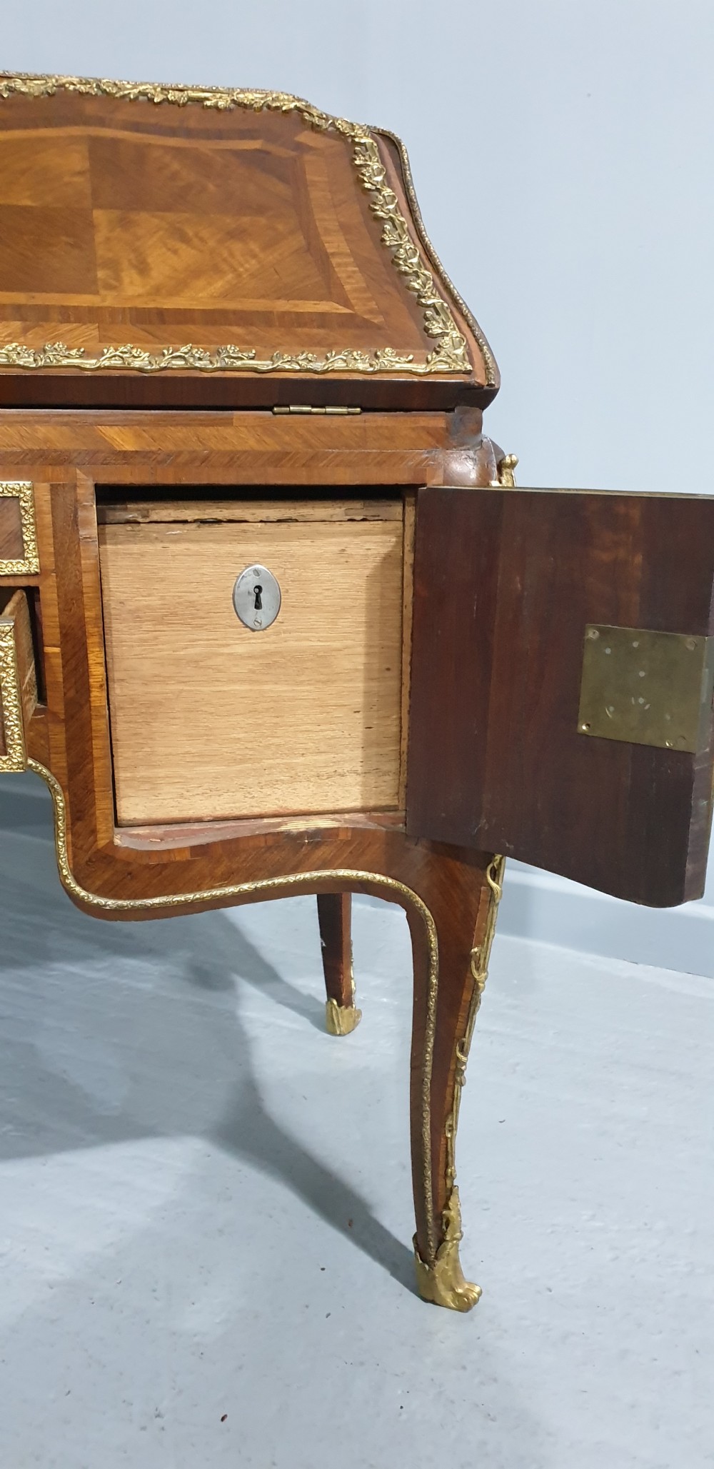 An early nineteenth-century French kingwood parquetry slant-front bureau featuring gilt-bronze ormolu mounts, cabriole legs, and geometric timber inlay. View XV
