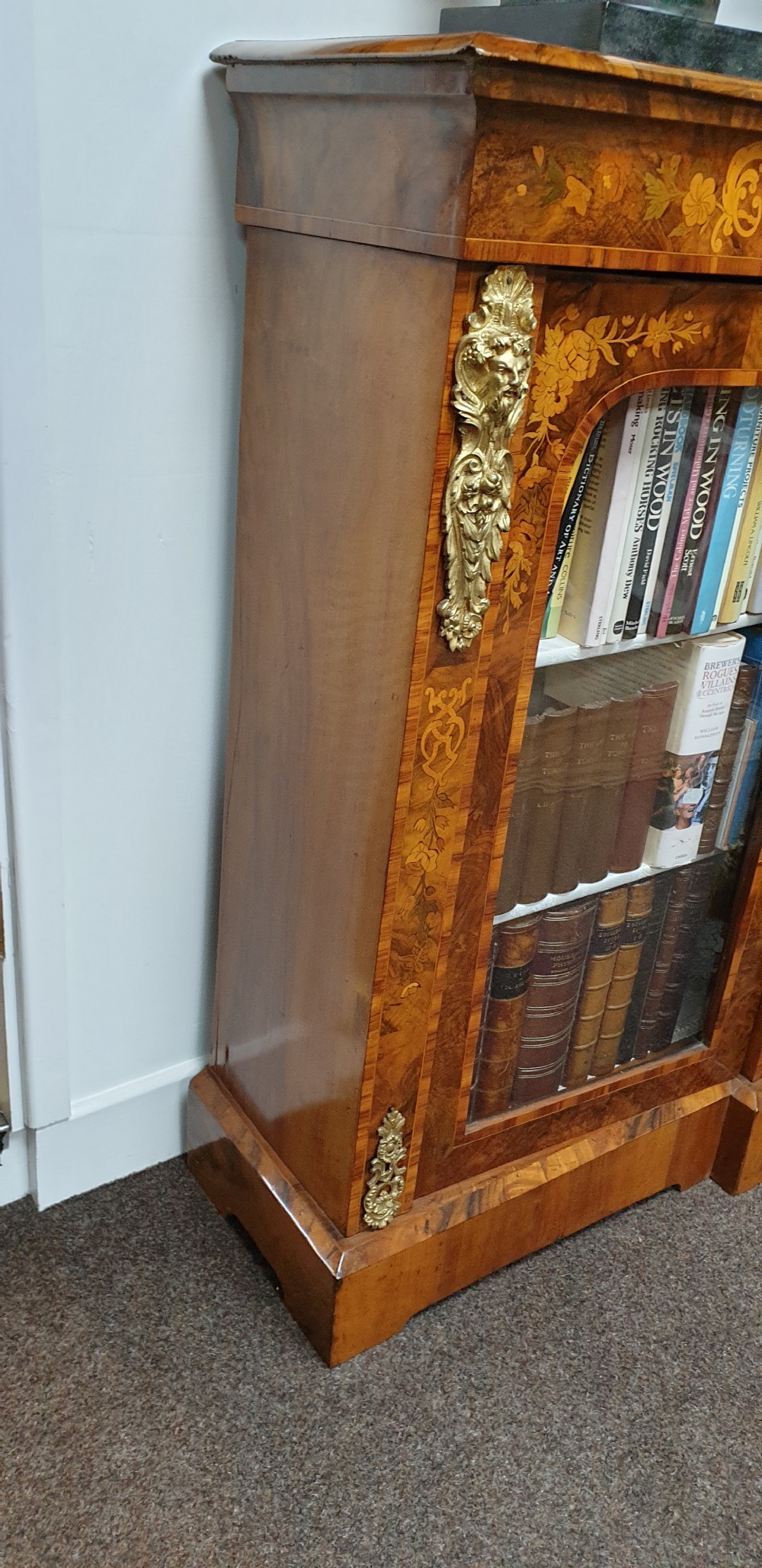 A low burr walnut and floral marquetry credenza bookcase featuring glazed side doors, a central solid panel door, and ornamental gilt-bronze mounts. View VII