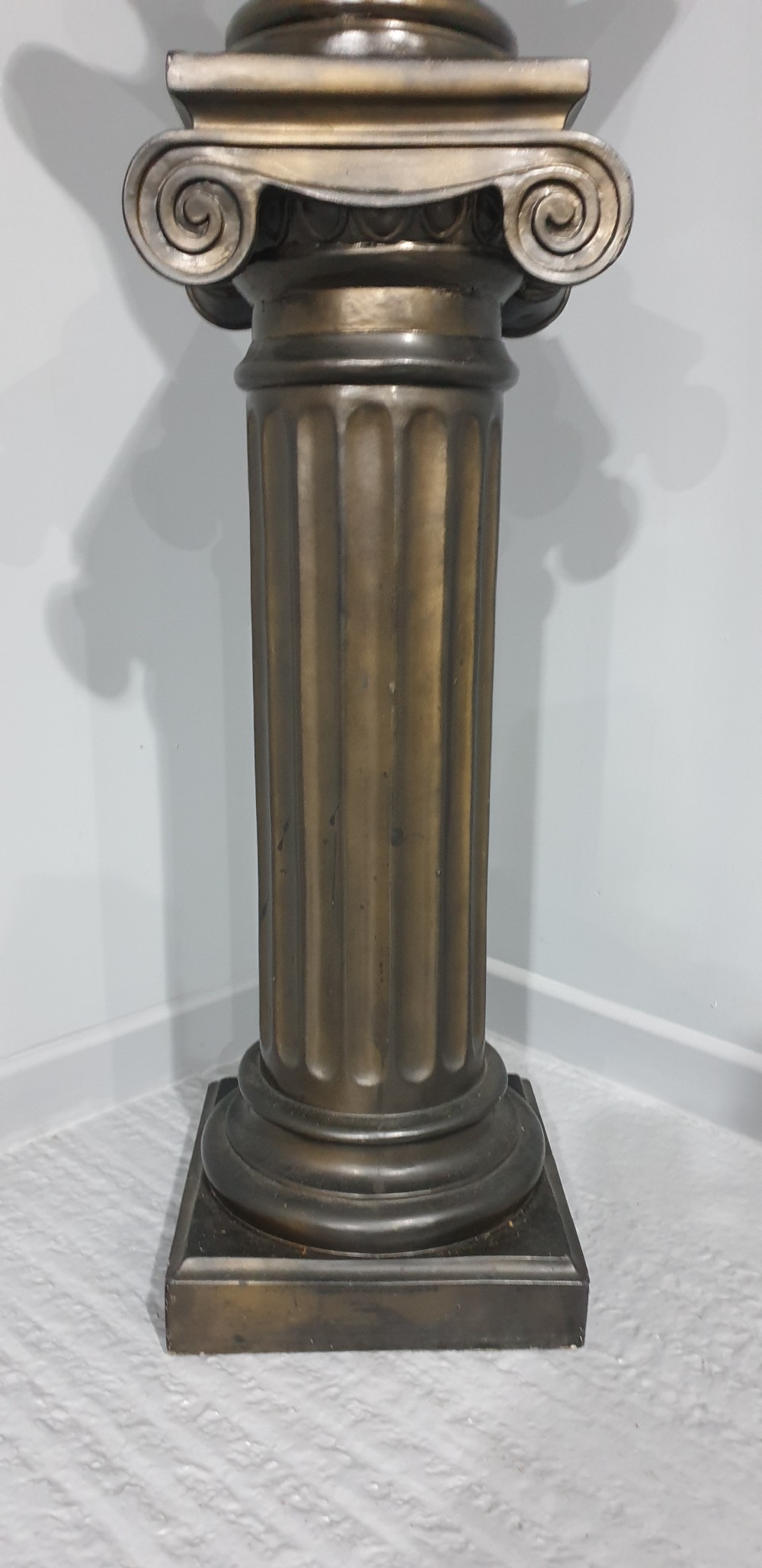 A bronze-patinated plaster bust depicting Michelangelos David mounted on a matching fluted Ionic column pedestal. View VI