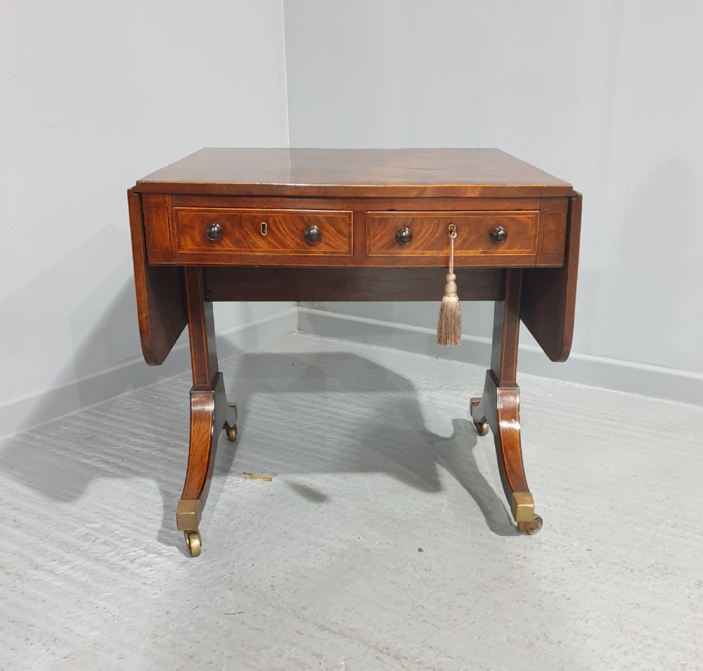An 18th-century mahogany drop-leaf sofa table with two frieze drawers, crossbanded inlay, sabre legs, and brass castors. View III