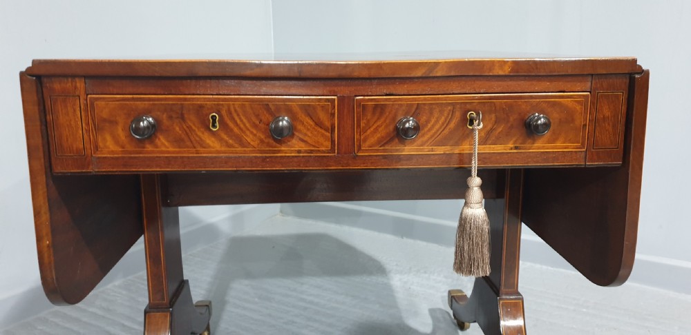 An 18th-century mahogany drop-leaf sofa table with two frieze drawers, crossbanded inlay, sabre legs, and brass castors. View IV