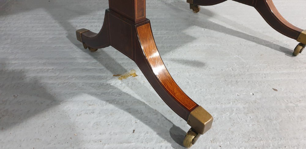 An 18th-century mahogany drop-leaf sofa table with two frieze drawers, crossbanded inlay, sabre legs, and brass castors. View X