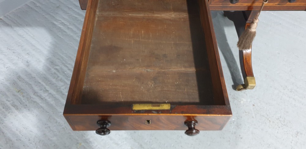 An 18th-century mahogany drop-leaf sofa table with two frieze drawers, crossbanded inlay, sabre legs, and brass castors. View XIV