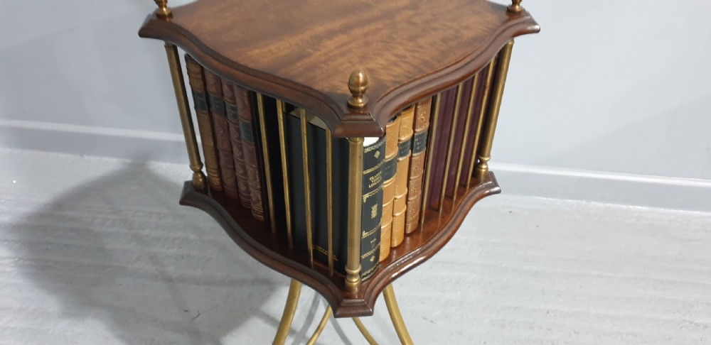 A small square revolving mahogany bookstand featuring brass vertical spindles, corner finials, and a tall tripod brass base with claw feet. View VII