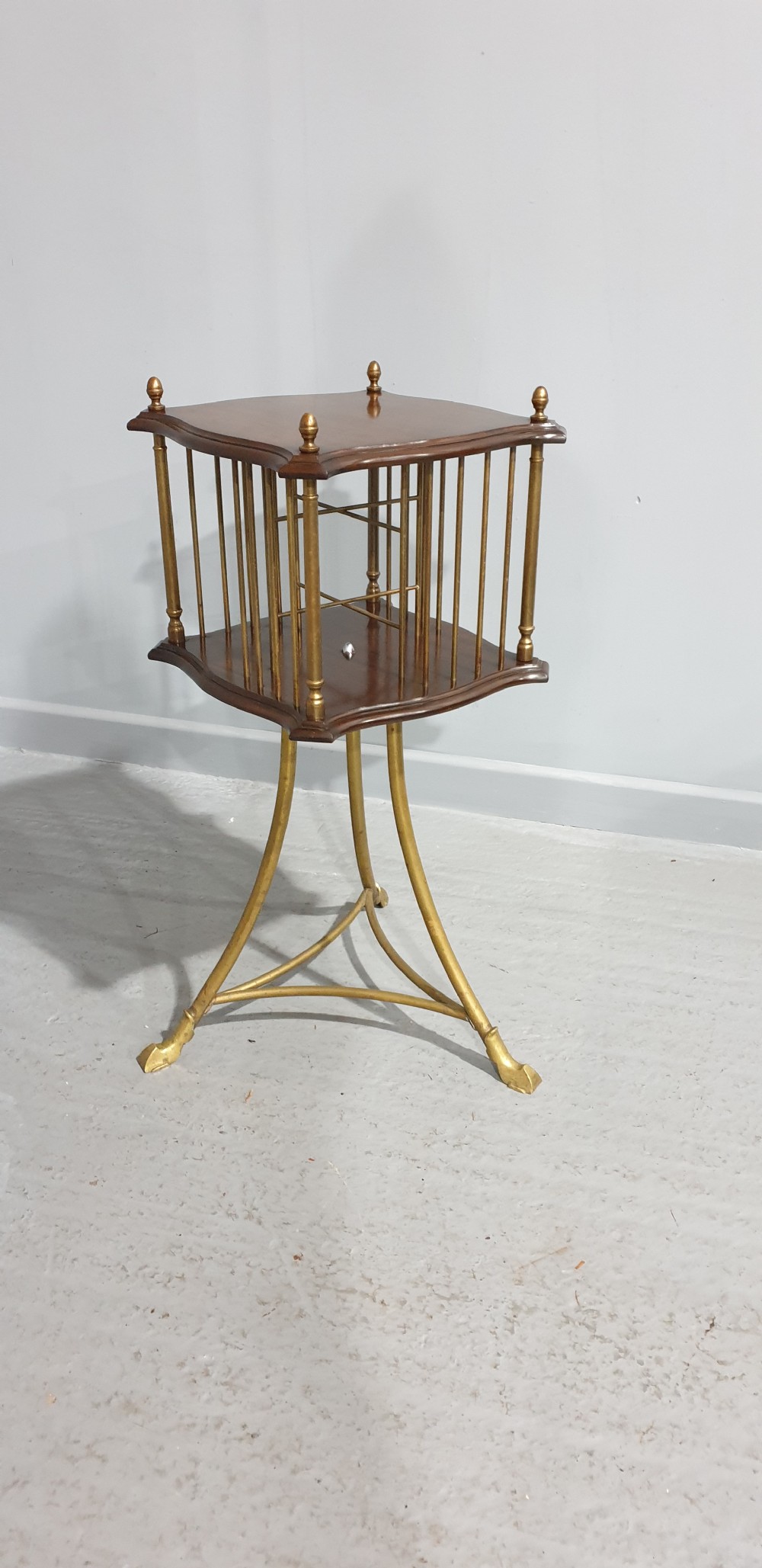 A small square revolving mahogany bookstand featuring brass vertical spindles, corner finials, and a tall tripod brass base with claw feet. View VIII