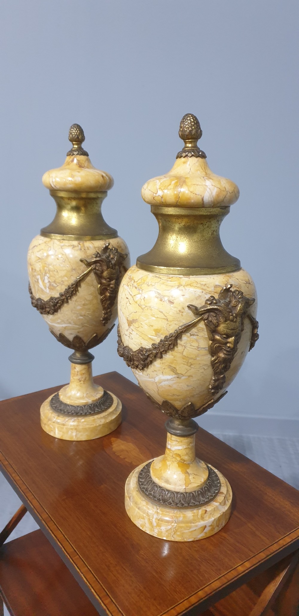 A pair of yellow veined marble cassolette urns with gilt bronze floral swags and pineapple finials. View III