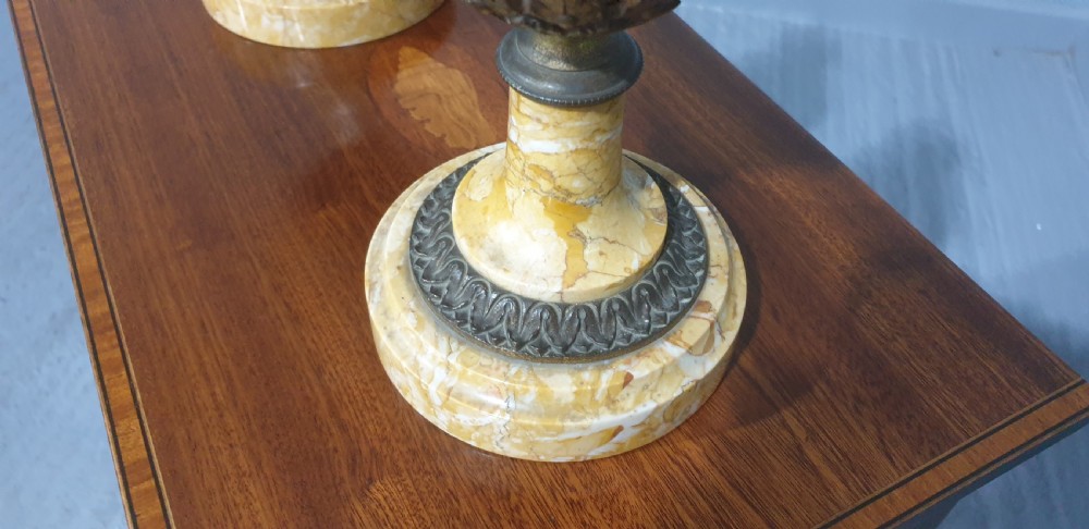 A pair of yellow veined marble cassolette urns with gilt bronze floral swags and pineapple finials. View V