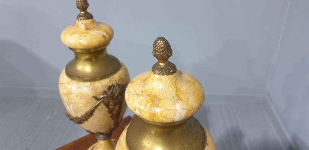 A pair of yellow veined marble cassolette urns with gilt bronze floral swags and pineapple finials. View VII