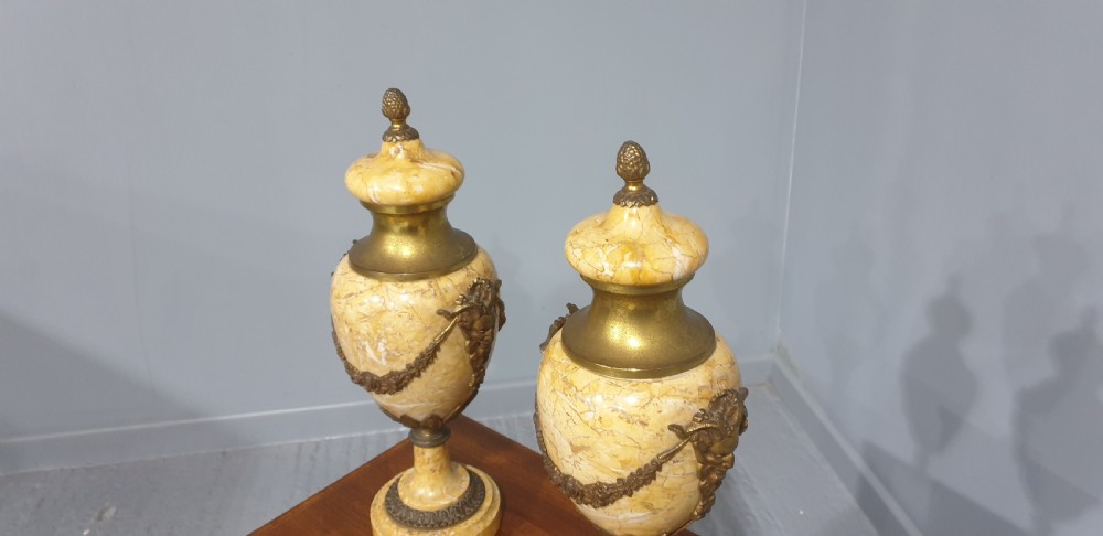 A pair of yellow veined marble cassolette urns with gilt bronze floral swags and pineapple finials. View VIII