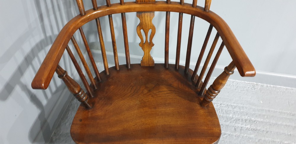 A traditional ash and elm Windsor armchair featuring a hoop back, central pierced splat, turned spindles, and a contoured wooden seat. View IV