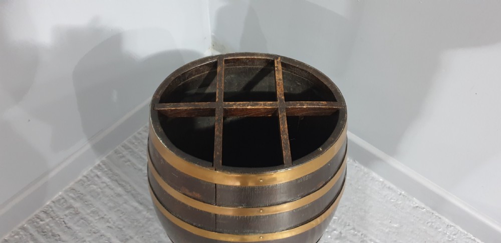 A dark oak barrel stick stand bound with brass hoops and featuring internal grid dividers at the top. View IV